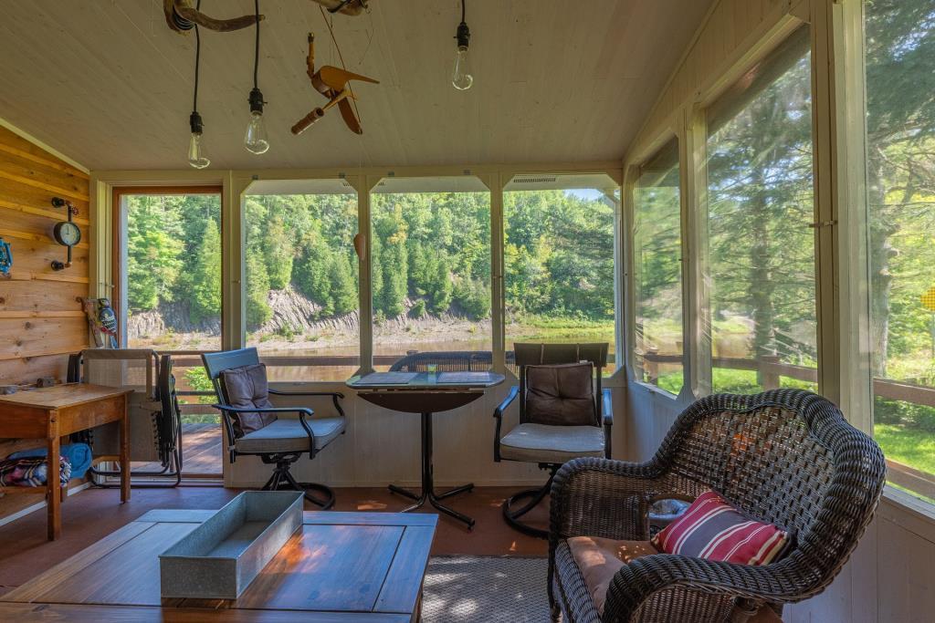 Warm weather awaits at this small riverside retreat for $149,000