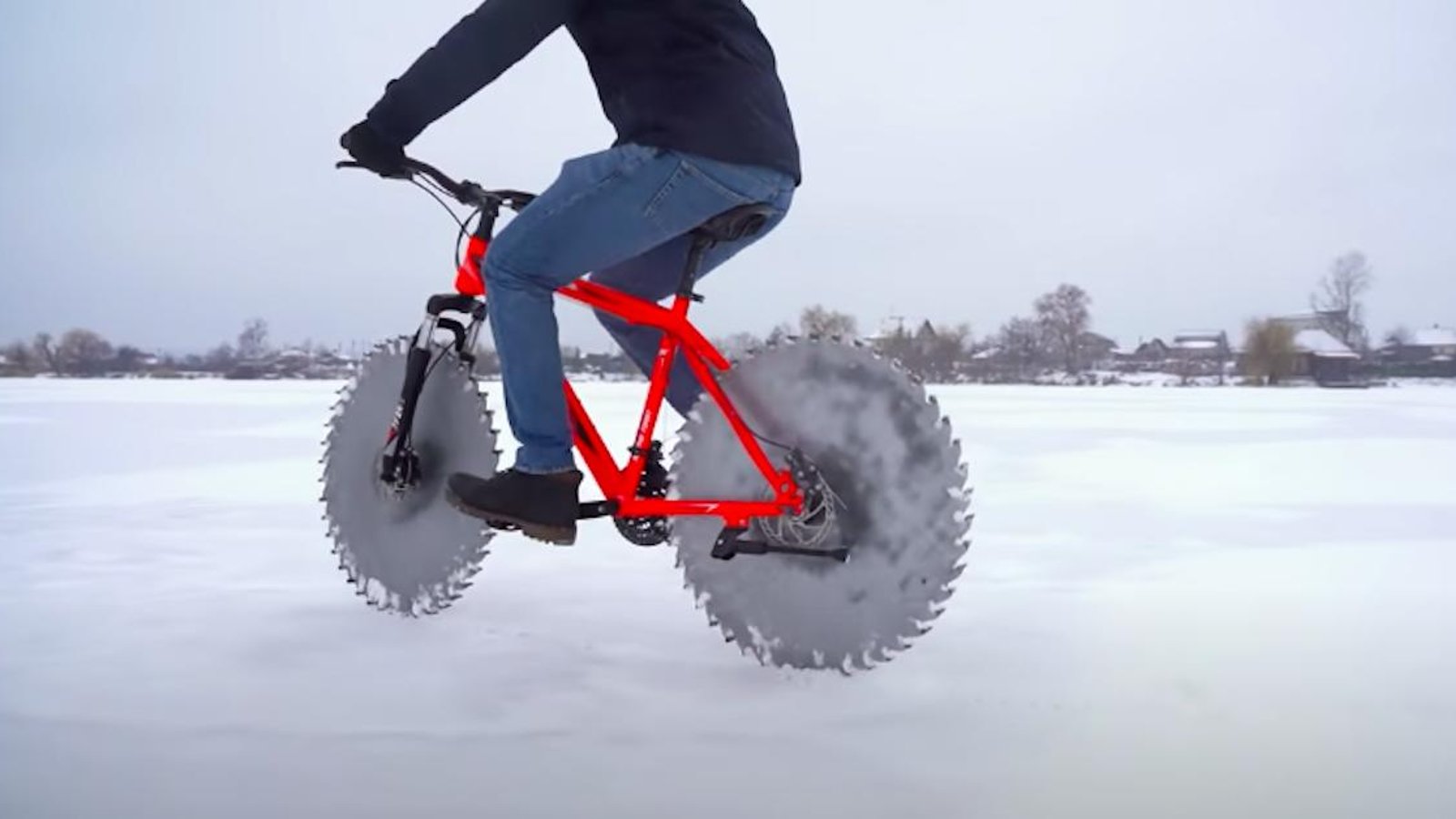 Pour pédaler sur un lac gelé sans déraper, il remplace les roues de son vélo de manière très inusitée!