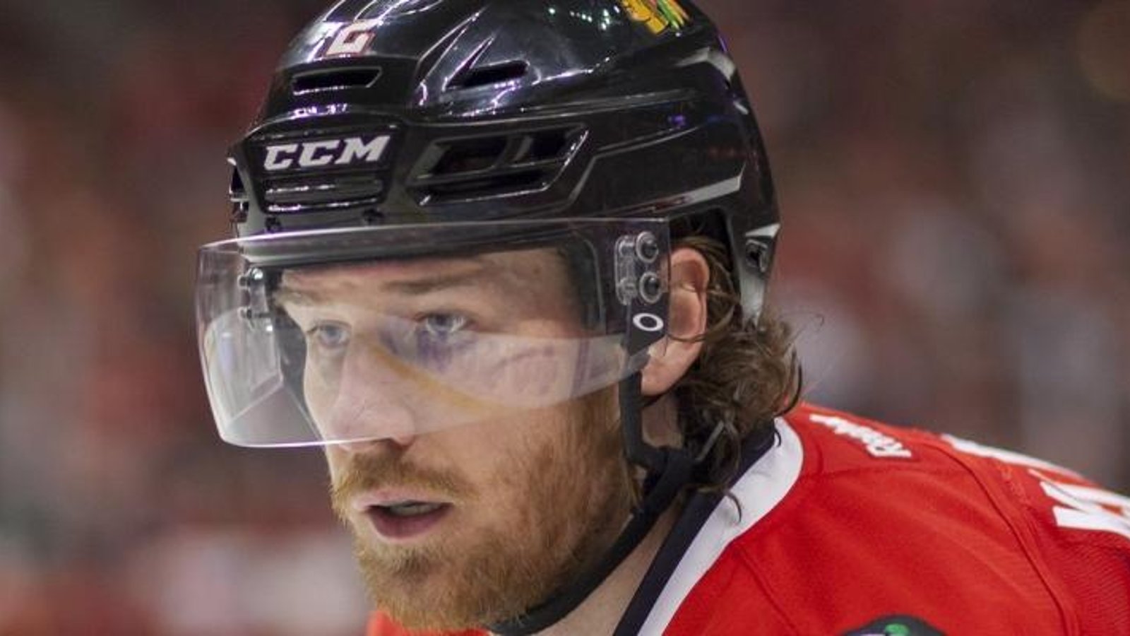 Blackhawks star Duncan Keith swings his stick at another player's face.