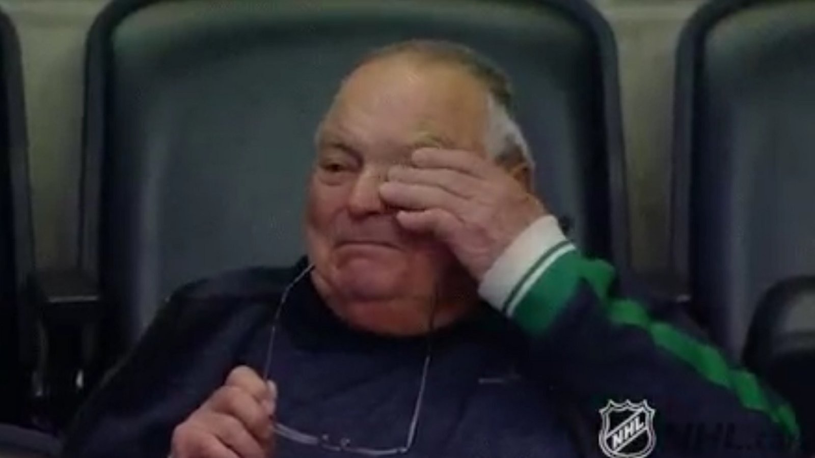 Grandpa  in tears as he watches his grandson in his first NHL game.