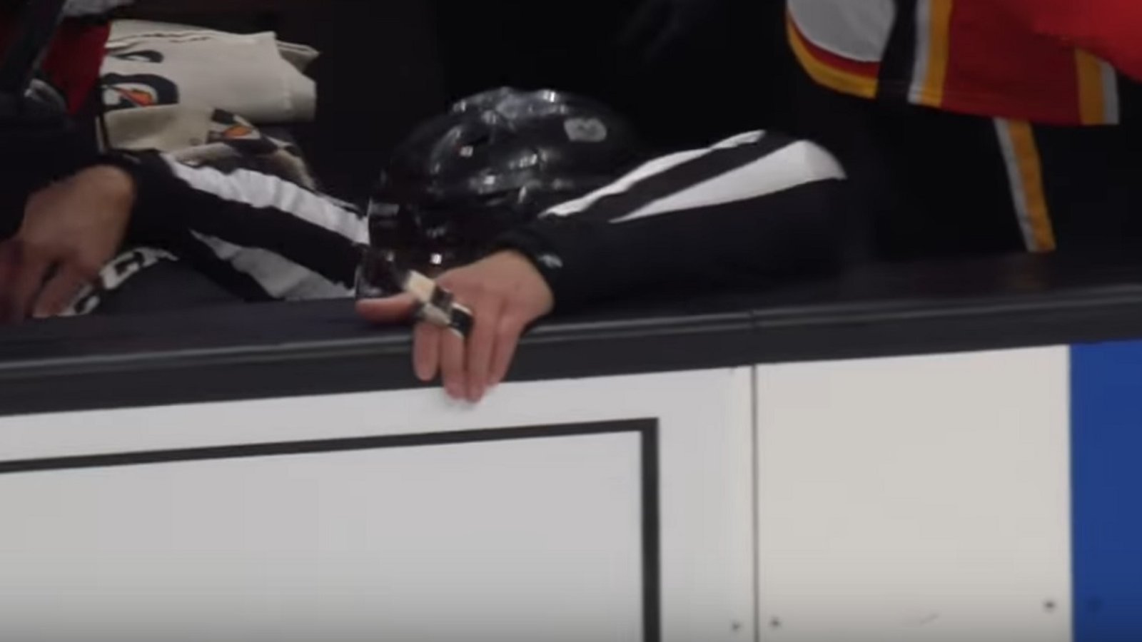NHL Linesman Brian Murphy gets sent crashing into the bench.