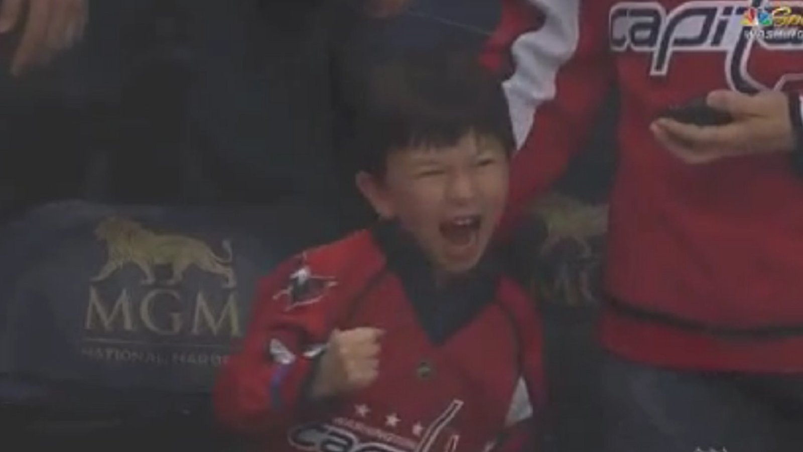 Backstrom gives puck to a young fan, his reaction is unforgettable. 