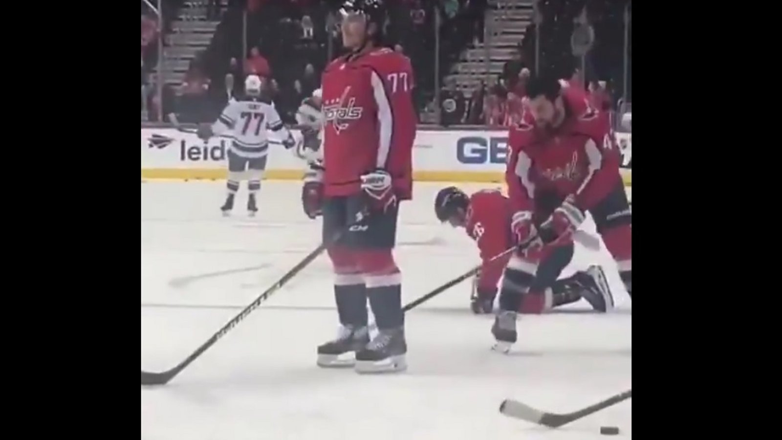 Tom Wilson gives TJ Oshie a low blow before the start of the game.