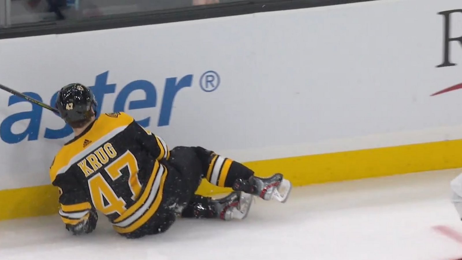 Torey Krug leaves the game after a big hit from Tom Wilson.