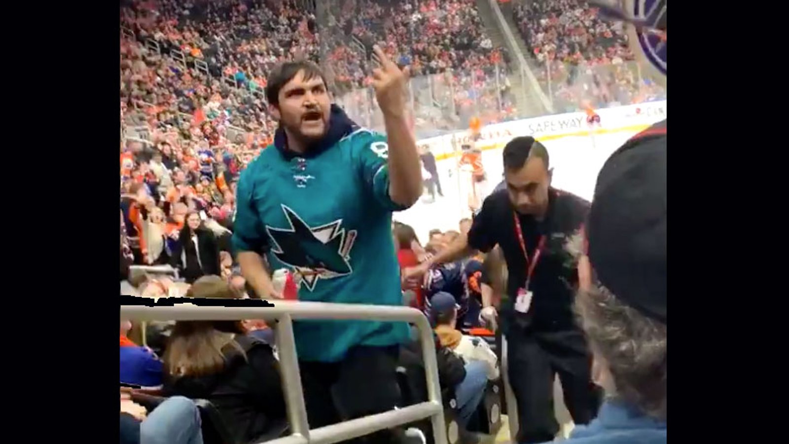 Drunk Sharks fan gets tossed from game and throws beer in Oilers fan’s face! 