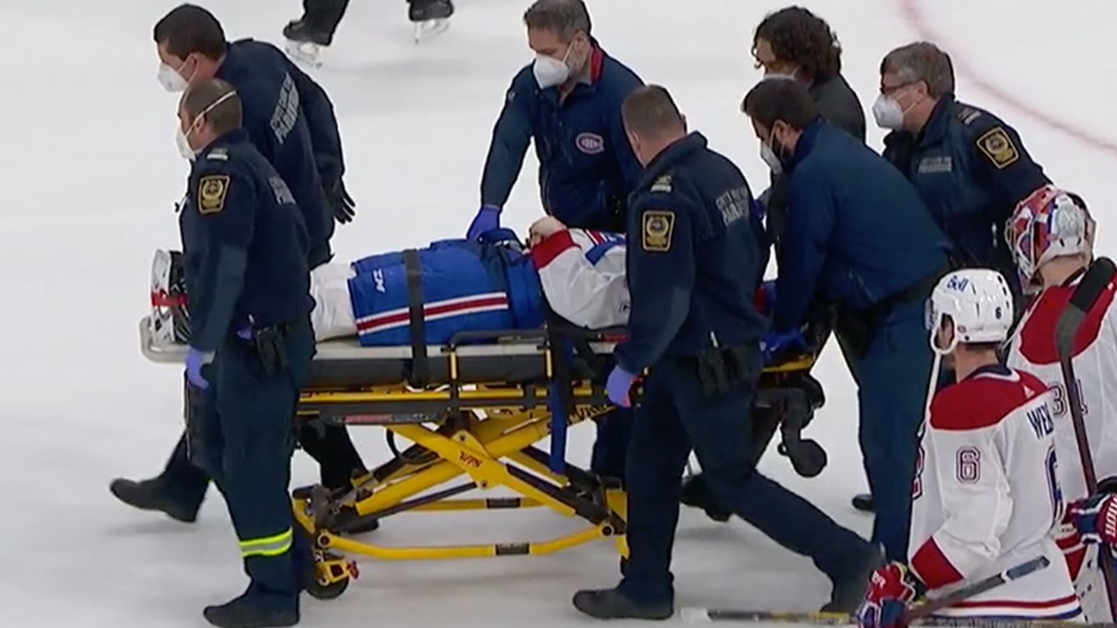 Jake Evans leaves on a stretcher after brutal hit from Mark Scheifele
